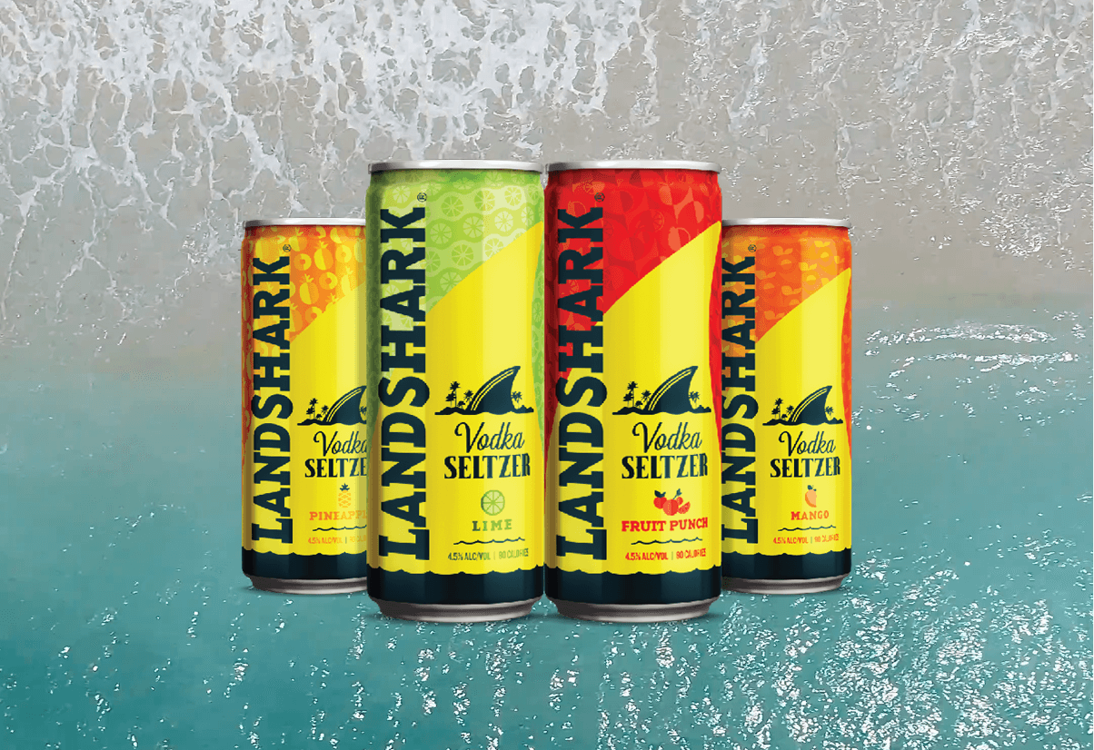 LandShark Vodka Seltzer variety arranged against a coastal water background